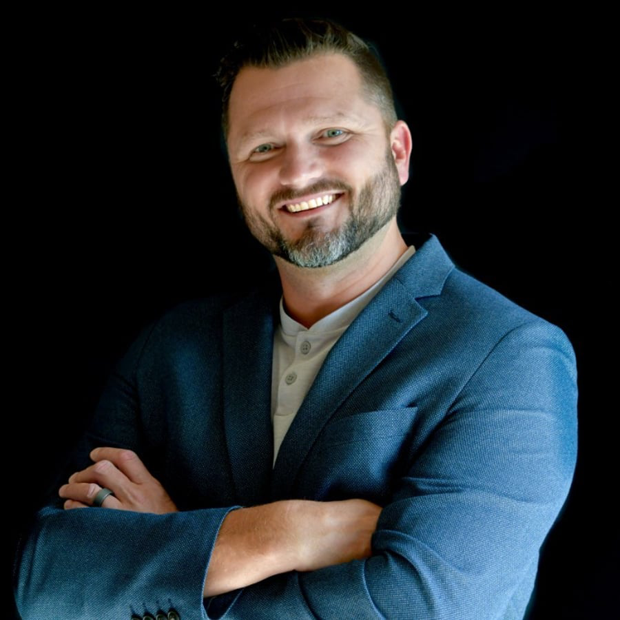 Man posing against a dark background