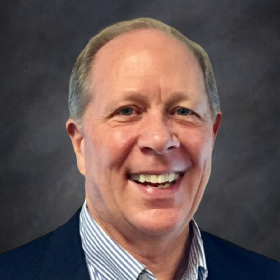 Smiling middle-aged man in a suit jacket and striped shirt.
